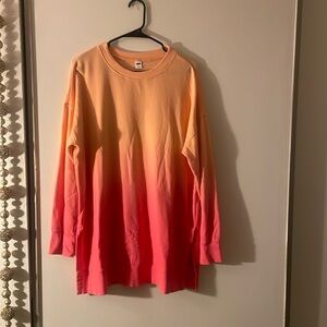 Orange and pink long sleeve sweater with slits on the side